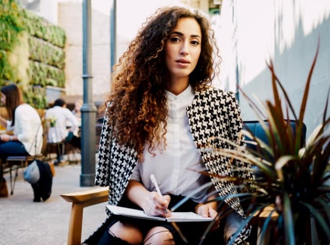 Lady writing in notepad